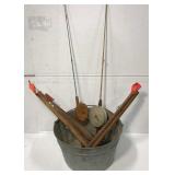 Old ice fishing gear in galvanized bucket