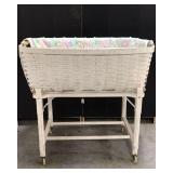 Vintage wicker bassinet on caster wheels