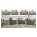Four gray stacking chairs