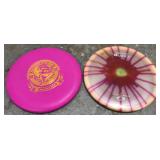 Two Discraft disc golf discs