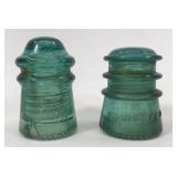 Two aqua glass insulators
