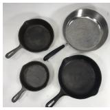 Three cast iron pans + Revereware pan