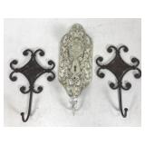Three ornate metal wall hangers
