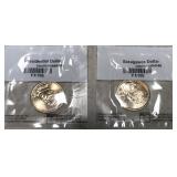 Two uncirculated $1 coins