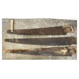 Three large antique lumber saws