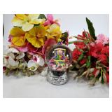 Globe with assorted fake flowers