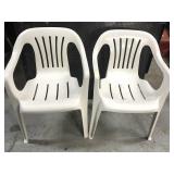 Two white patio chairs