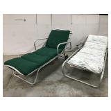 Two vintage metal patio loungers on wheels