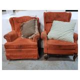 2 orange arm chairs with accent pillows