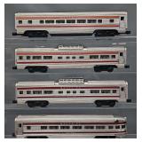 Four Lionel Postwar O Extruded Aluminum Passenger Cars with Reproduction Stripes