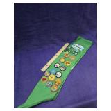 Girl scout sash with patches and pins