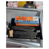 Box of ho track and vintag model train ephemrah.
