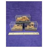 Lot of 3 vintage wooden model cars in display