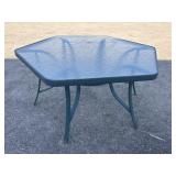 Green metal framed glass top patio table