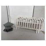 Metal bird feeder & white garden fencing sections