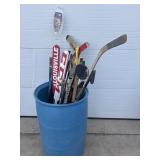Blue barrel with hockey sticks, misc