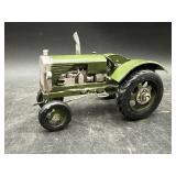 Small green metal tractor