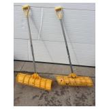 2 yellow snow shovels
