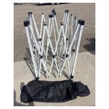 White metal gazebo frame on black bag