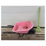 Childs pink wheel barrow and green rake