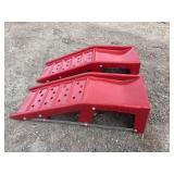 2 red metal car ramps