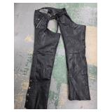 black leather biker chaps are by the brand Unik