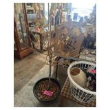 Potted artificial tree with decorative leaf base