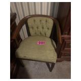 Upholstered wooden armchair with green tufted