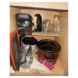 Cabinet contents: slow cooker, coffee makers,