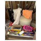 Cabinet contents: household cleaners, towels,