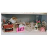 Contents of shelf - mini sewing machine, bells,