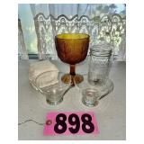 Assorted glassware including amber goblet, mason