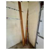Assorted long-handled poles, rods, and yard/tool