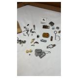Small gun pieces, key chains, mood ring, dog