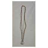 14 karat floating diamond pendant on four strand