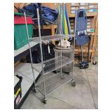 Metal Shelf Unit On Wheels With 3 Shelves. 69 Inches H By 46 1/2 Inches W By 18 Inches Deep