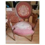 Wooden chair with designs engraved throughout including back cushioning