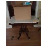 30x33 wooden table on wheels with a box of miscellaneous items 30x33 wooden table on wheels with a box of miscellaneous items