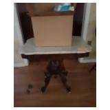 30x33 wooden table on wheels with a box of miscellaneous items