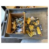 Box of dremel tool attachments and driver bits.