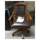 Upholsted Caster Game arm chair. Display.