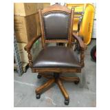 Upholsted Caster Game arm chair.
