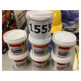 Seven cans of window glazing compound.