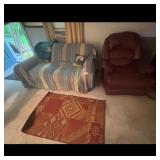 Striped Sofa and Burgundy Recliner with Area Rug