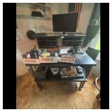 Desk with Monitor, Electronics, and Coca-Cola Crat