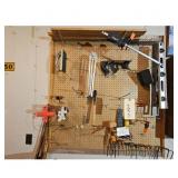Assorted Tools and Hardware on Pegboard in Worksho