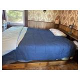 Queen bed with storage drawers underneath, lamp