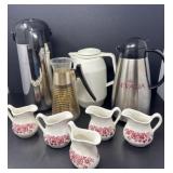 Five Creamers and Four Carafes
