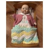 Porcelain Doll in Cradle