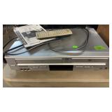 PANSONIC DVD/VHS PLAYER W/ REMOTE & BOOK